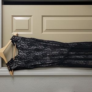 Black full- length, sleeveless, lace dress with nude slip insert. Size 10-12.